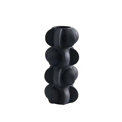 Black ceramic vase with textured segmented design resembling stacked spheres for modern geometric spiral decorbites geometric spiral resin decor