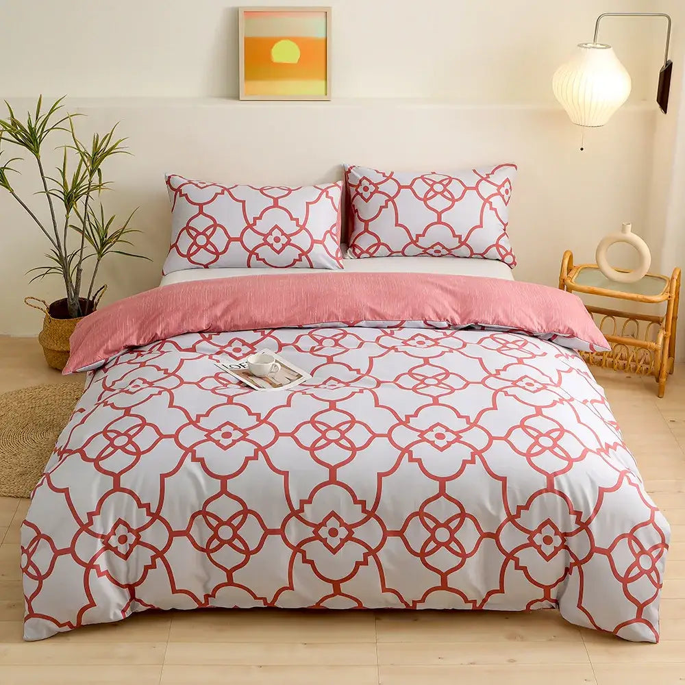White duvet cover bedding set with red geometric triangle block print and matching pillowcases with pink bed skirt