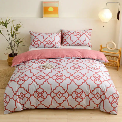 White duvet cover bedding set with red geometric triangle block print and matching pillowcases with pink bed skirt