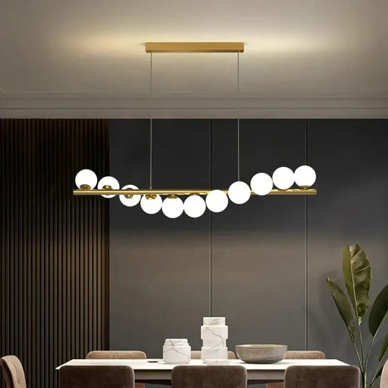 Modern glass ball gold chandelier pendant light with sleek horizontal bar and white spherical glass globes for dining room decorbites glass ball