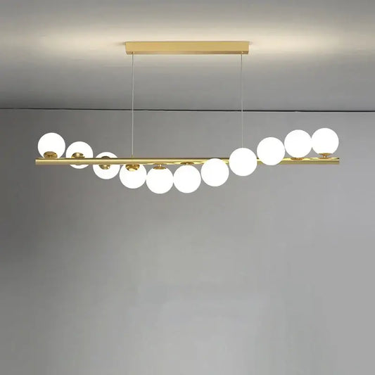 Modern glass ball gold chandelier featuring a sleek horizontal bar with white spherical glass globes for dining room decorbites glass ball pendant light