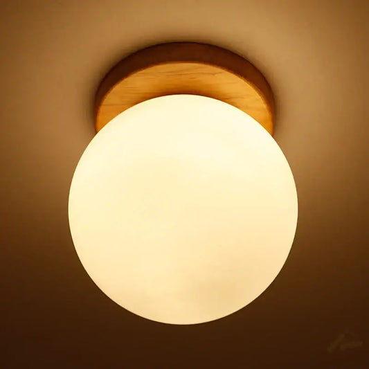 Warm-toned modern glass ball led ceiling lamp with frosted glass globe and natural wood mount for bedroom decorbites decor