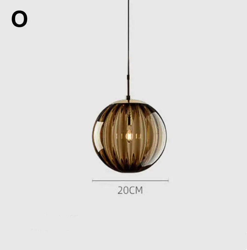 A sleek amber glass ball lustre pendant light with vertical ridges and visible filament bulb for modern decorbites pendant lights