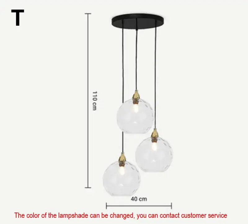 Modern three-light pendant lights with clear faceted glass ball lustre globes and black metal fixtures for kitchen decorbites