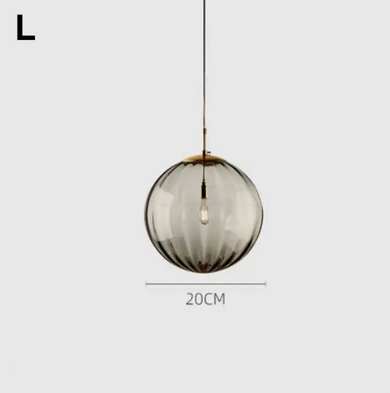 A sleek 20cm diameter decorbites glass ball pendant light with textured smoked glass and brass accents for kitchen decor