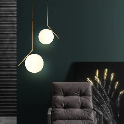 Modern gold-toned glass ball pendant light with frosted shades and metal arms for dining room decorbites pendant light