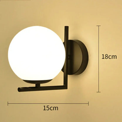 Black metal wall lamp with a frosted white glass ball globe perfect for modern bedroom decorbites glass ball sconce