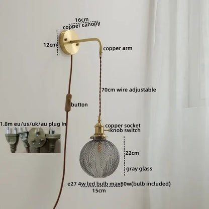 Modern glass copper led wall lights feature a brass-finished copper arm with gray etched glass globe for bedroom use
