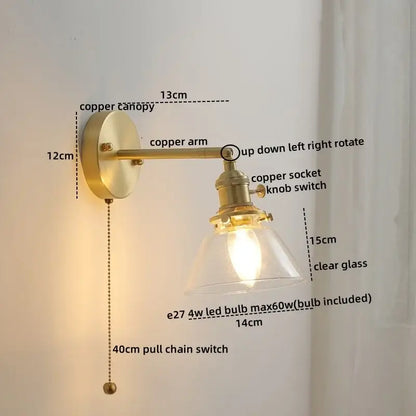 Brass-finished copper led wall light with clear glass shade and adjustable arm for modern bedroom reading use