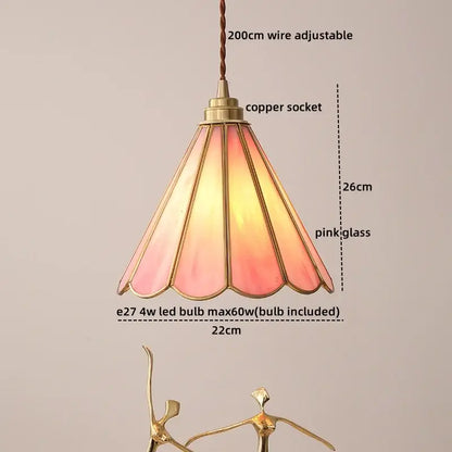 Modern glass copper pendant light with a delicate pink stained glass shade and adjustable copper socket for dining room use