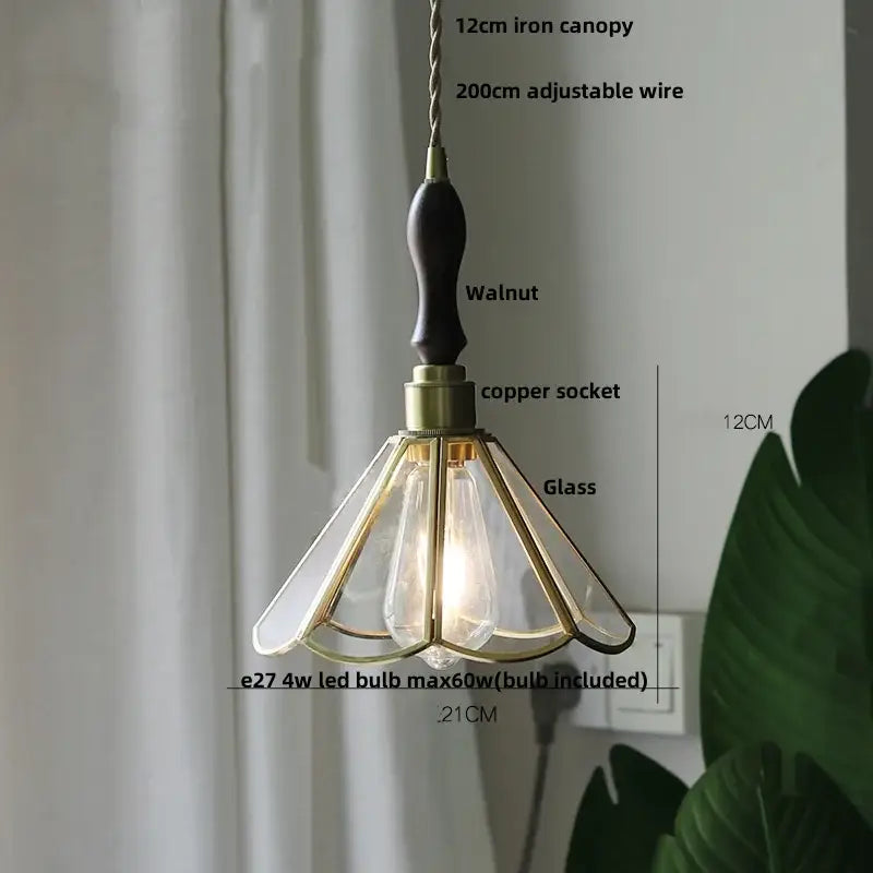Modern glass flower led pendant light with dark walnut wooden handle brass accents and gold-toned metal framing for dining room