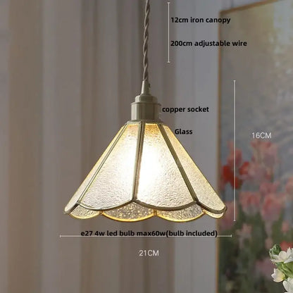 A warm textured glass flower led pendant light with copper socket and iron canopy for dining room illumination