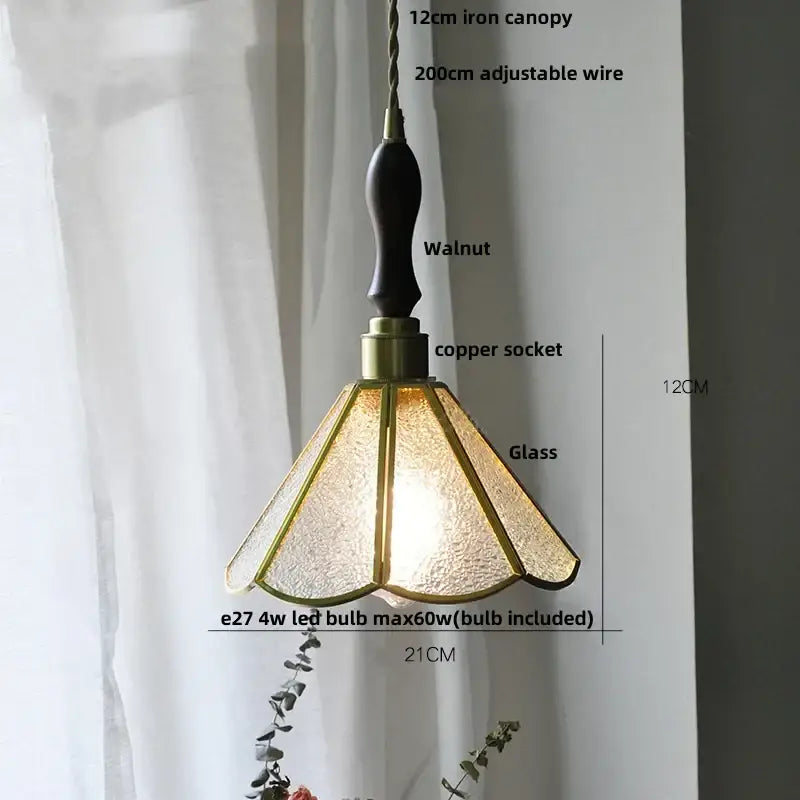 A warm-toned glass flower led pendant light with textured glass and walnut iron canopy for dining room lighting