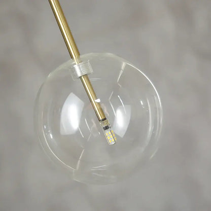 Modern glass globe chrome pendant light with clear glass globe, brass-finished rod, and led bulb for dining room