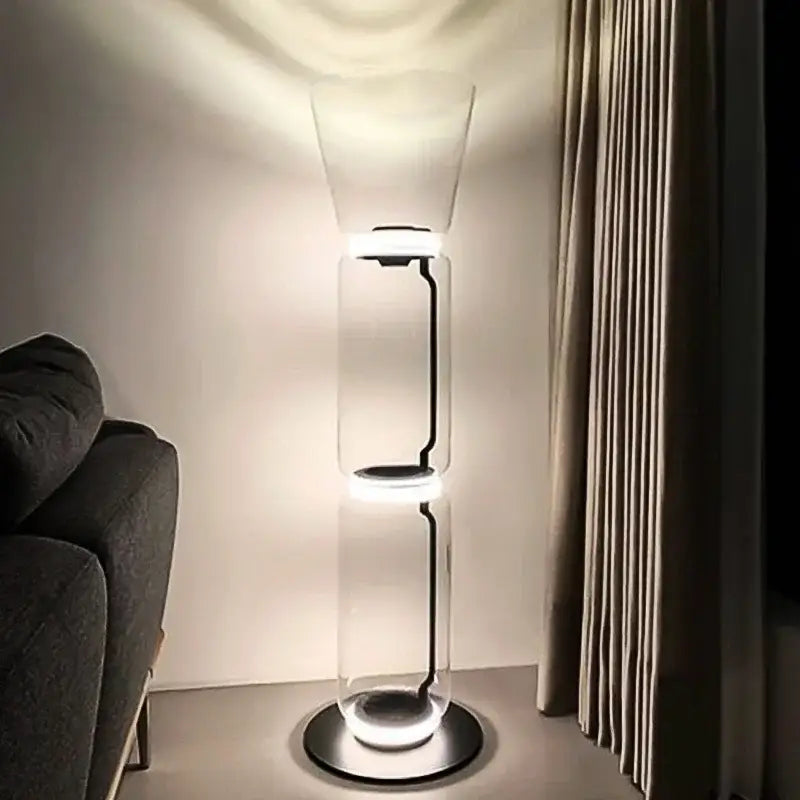 Modern glass led floor lamp with transparent cylindrical body and soft white glowing rings for living room use