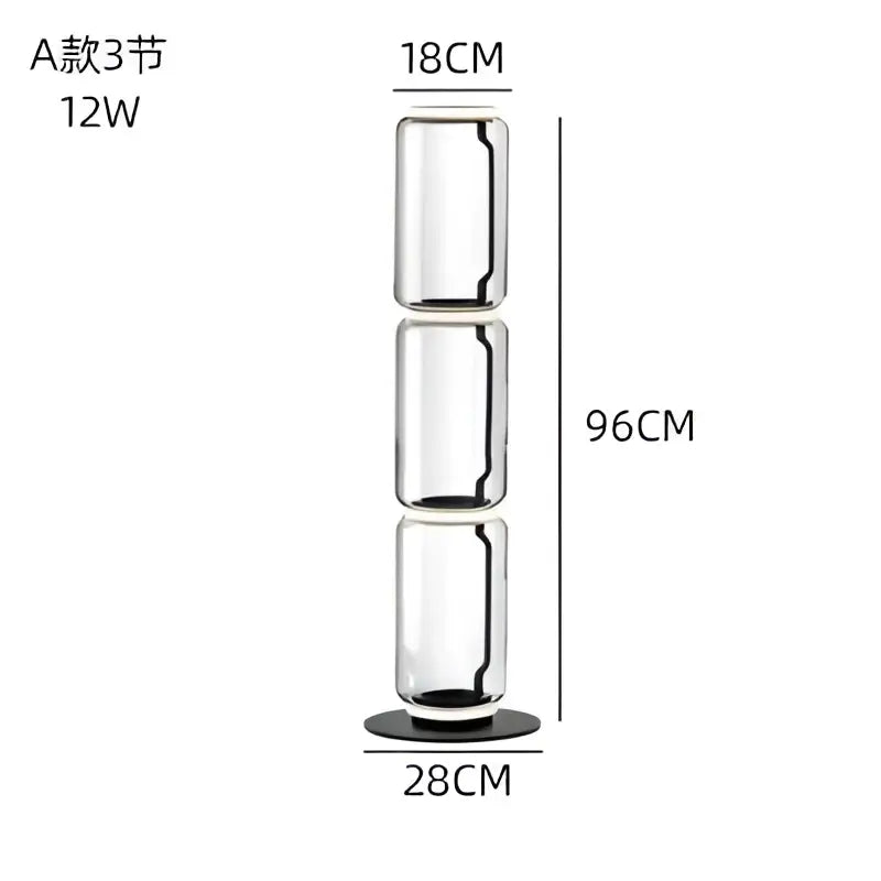 A tall transparent modern glass led floor lamp with three cylindrical sections and black base for living room