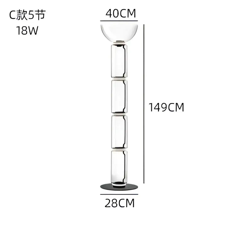 A tall slender modern glass led floor lamp with clear cylindrical body and glowing rings for living room use