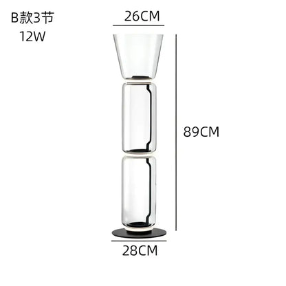 Modern glass led floor lamp with tall transparent three-section design and black base for living room use