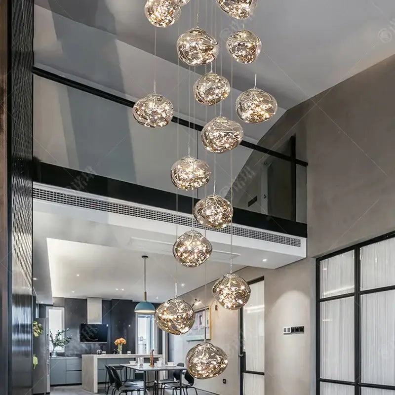 Modern glass orb pendant light with crackled metallic finish and internal led illumination using led bulbs