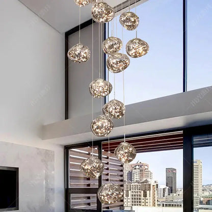 A modern pendant light with textured glass orbs featuring crackled finish and led illumination for living rooms