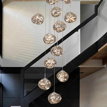 A modern glass orb pendant light with textured metallic frames and led bulbs providing warm led illumination