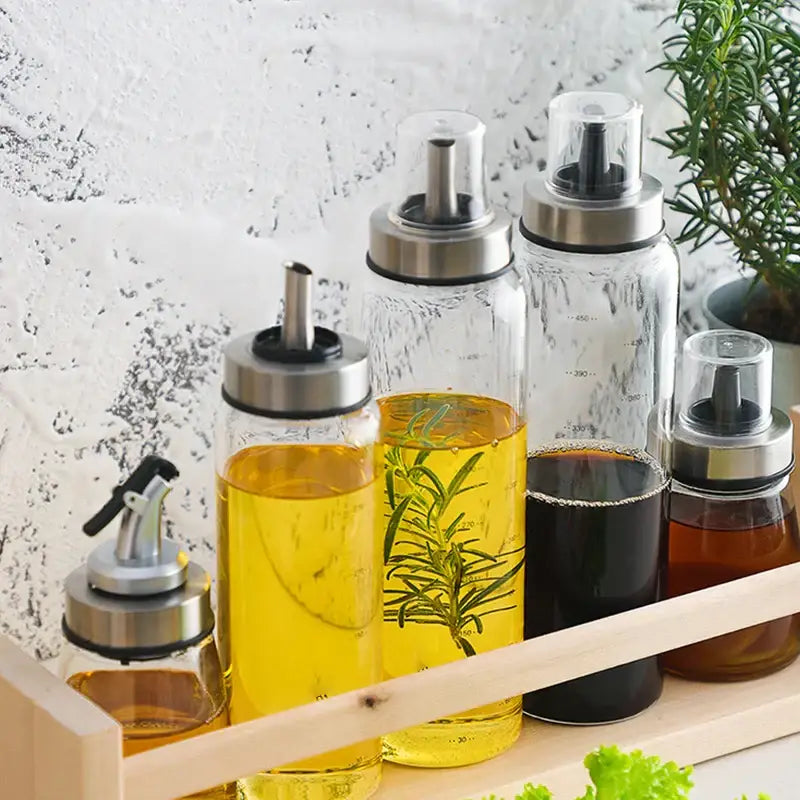 Modern glass seasoning storage bottle set with clear glass containers and stainless steel pumps for oil vinegar and honey