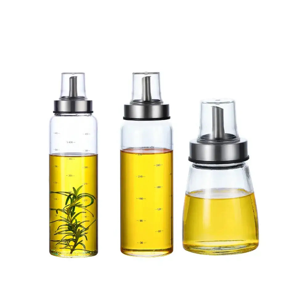 Modern glass seasoning storage bottle set with clear glass containers silver spouts and rosemary for kitchen organization