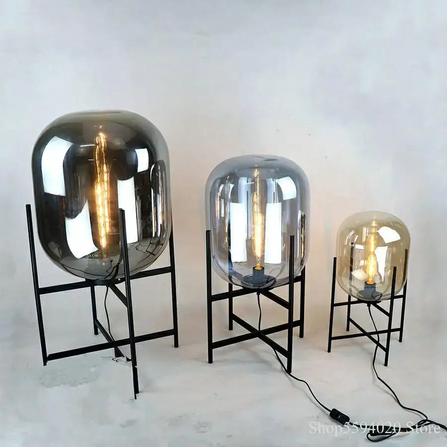 Set of three modern decorbites glass table lamps with black metal stands and exposed filament bulbs for living room decor