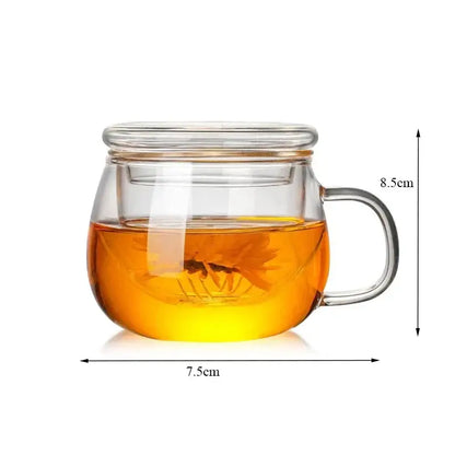 Modern glass tea cup with infuser and lid featuring clear glass tea cup and golden-brown brewed tea inside