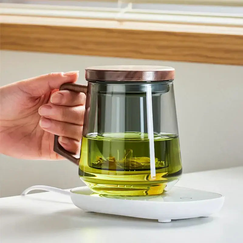 Modern glass tea cup with wood handle featuring decorbites glass tea clear infuser mug filled with green herbal infusion