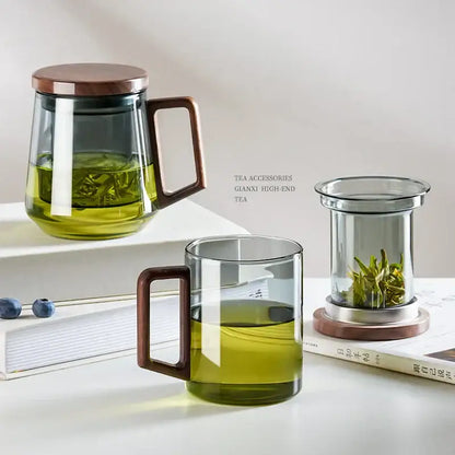 Clear glass teapot with wooden lid and handle filled with green tea for modern kitchen decorbites glass tea use