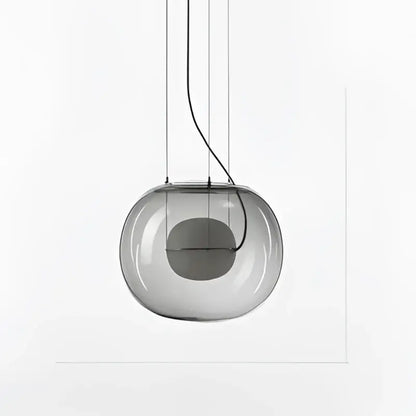 A sleek translucent gray glass ball pendant light with visible wiring from decorbites brokis big for modern dining room decor