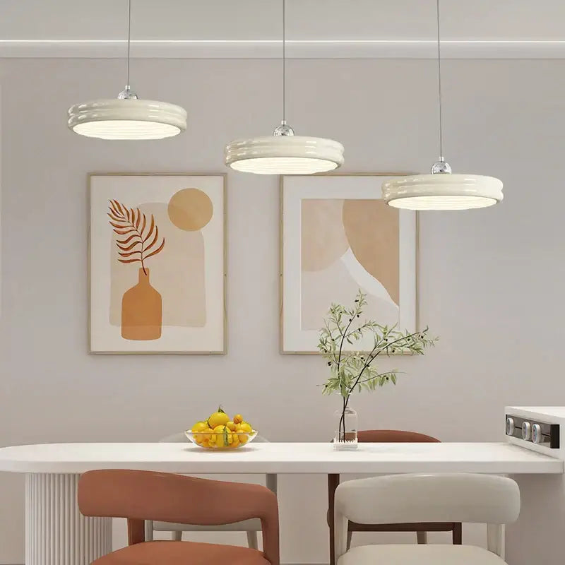 Three modern glossy pale yellow circular dimmable pendant lights with off-white ceramic shades for dining room decorbites circular dimmable