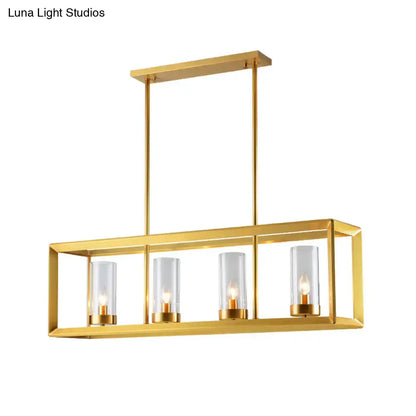 Gold-finished rectangular pendant light with clear glass shades and warm bulbs, ideal for dining room illumination