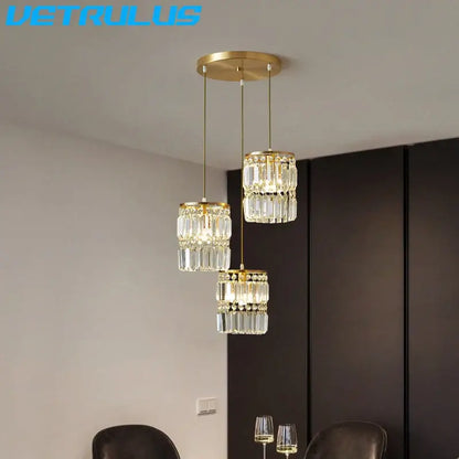 Modern gold 3 tier crystal chandelier pendant light featuring faceted glass elements for dining room lighting
