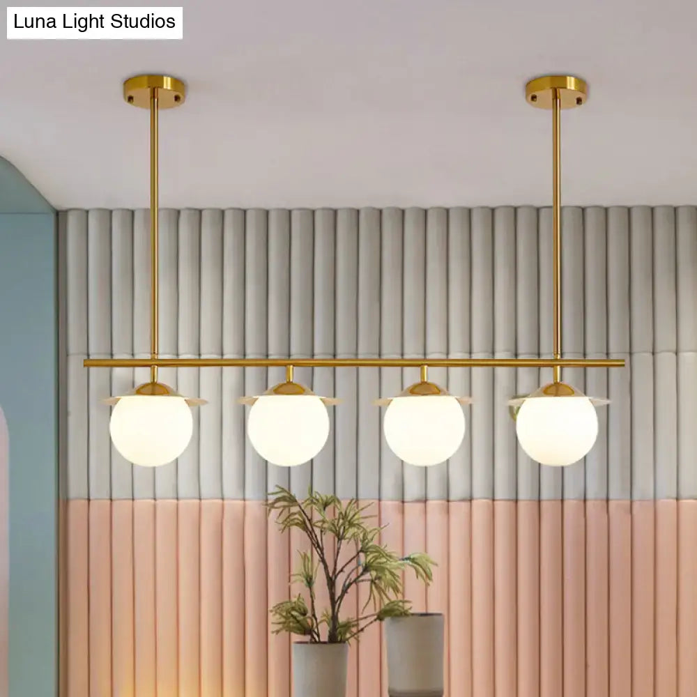 DecorBites gold opal glass round island pendant light with four frosted glass globes and contemporary round island design