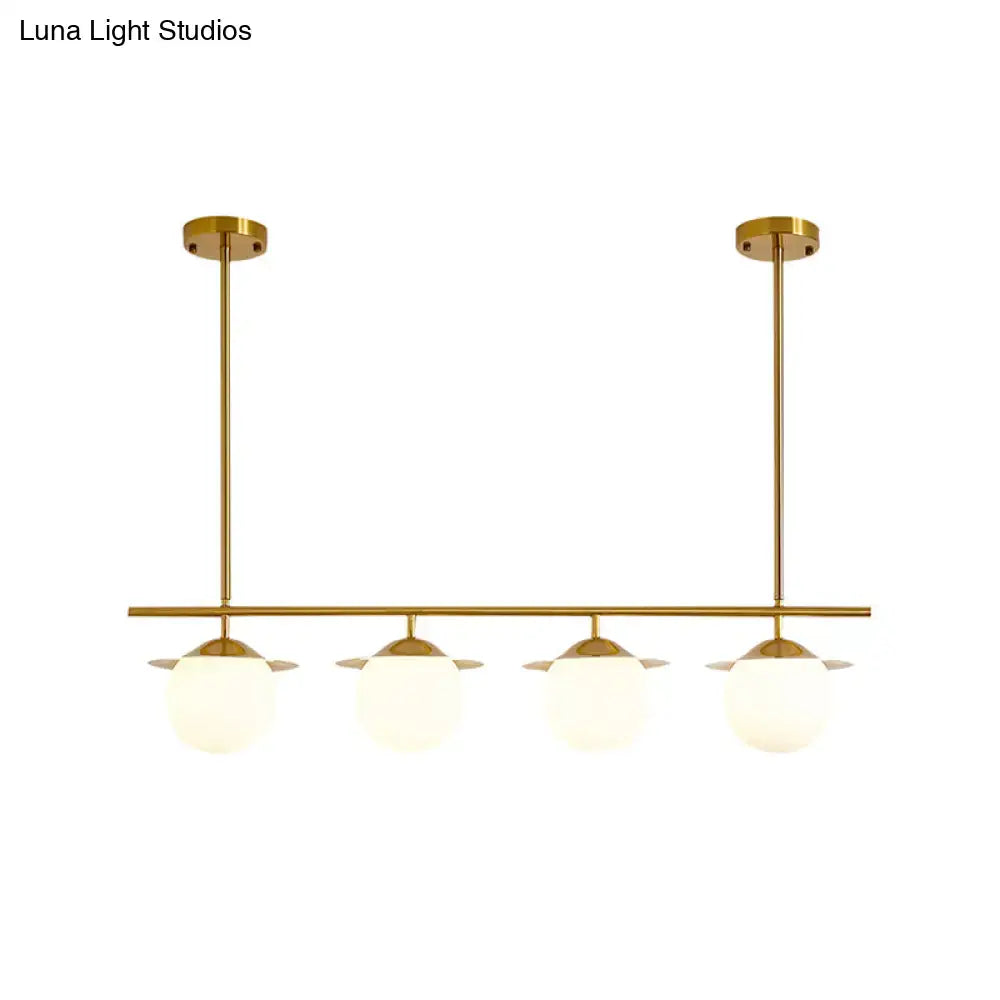 DecorBites gold pendant light with four frosted opal glass globes for contemporary round island lighting