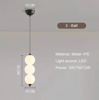 Modern gold 4 globe pendant light with black metal frame, plated gold-toned surface, and frosted white spheres as focal point