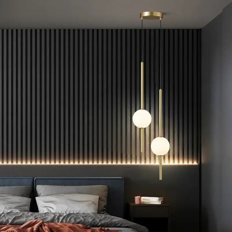 Modern gold 4 globe pendant light with plated gold-toned surface and frosted glass shades as a dining room focal point
