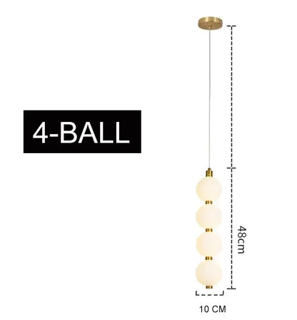 Modern gold 4 globe pendant light with plated gold-toned surface and frosted glass spheres as a dining room focal point