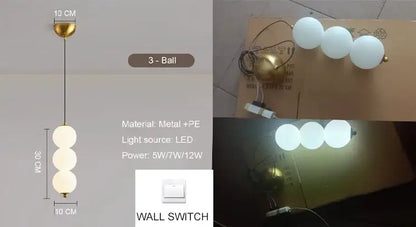 Modern pendant light with plated gold-toned surface and three frosted white globes as a dining room focal point