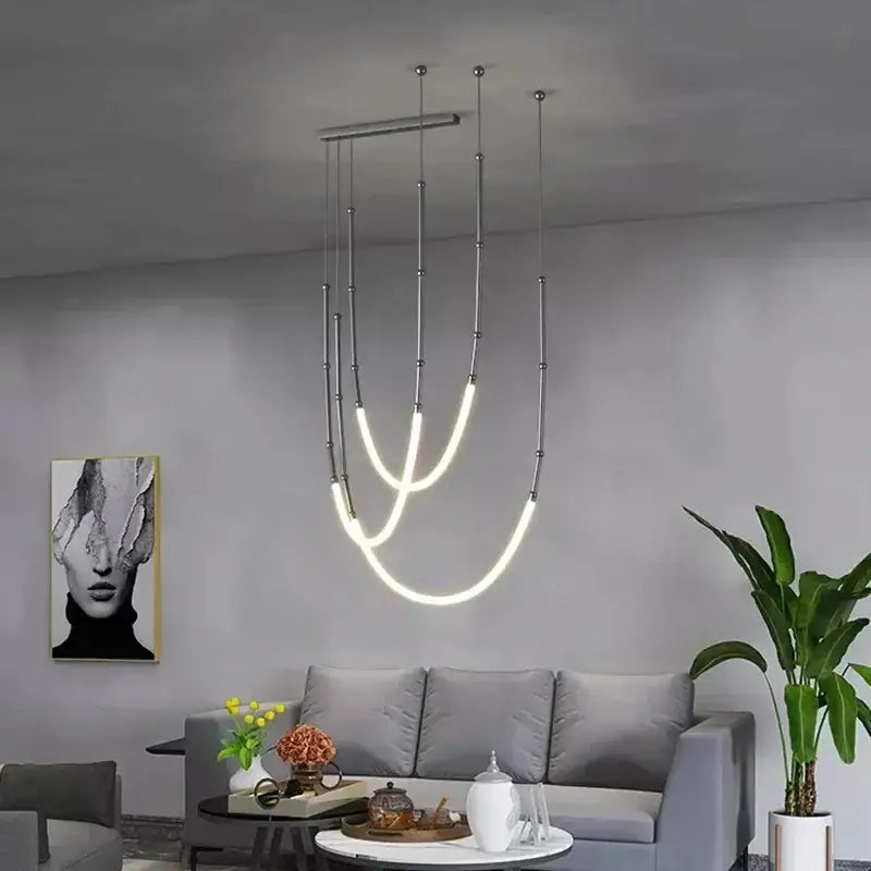 Modern gold acrylic bamboo pendant light with brushed nickel finish featuring sleek metallic rods and curved led strips