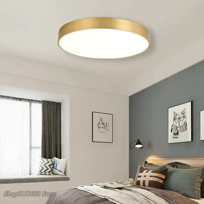 Modern gold acrylic led ceiling light with a round gold metallic frame and white illuminated center for living room