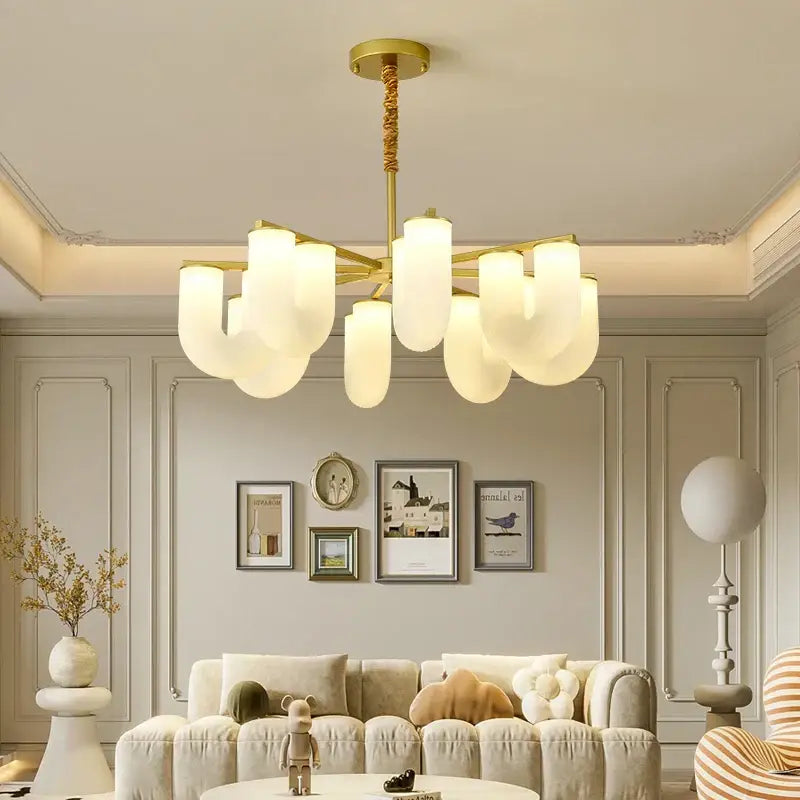 Modern gold metal acrylic pendant lights featuring a gold-toned chandelier with frosted glass shades for dining room