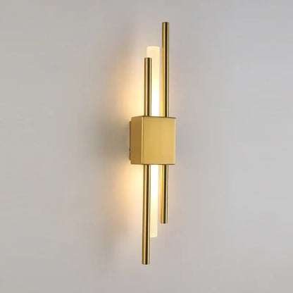 Modern gold acrylic pipe led wall lamp with sleek vertical rods and warm ambient lighting as a bedroom wall sconce