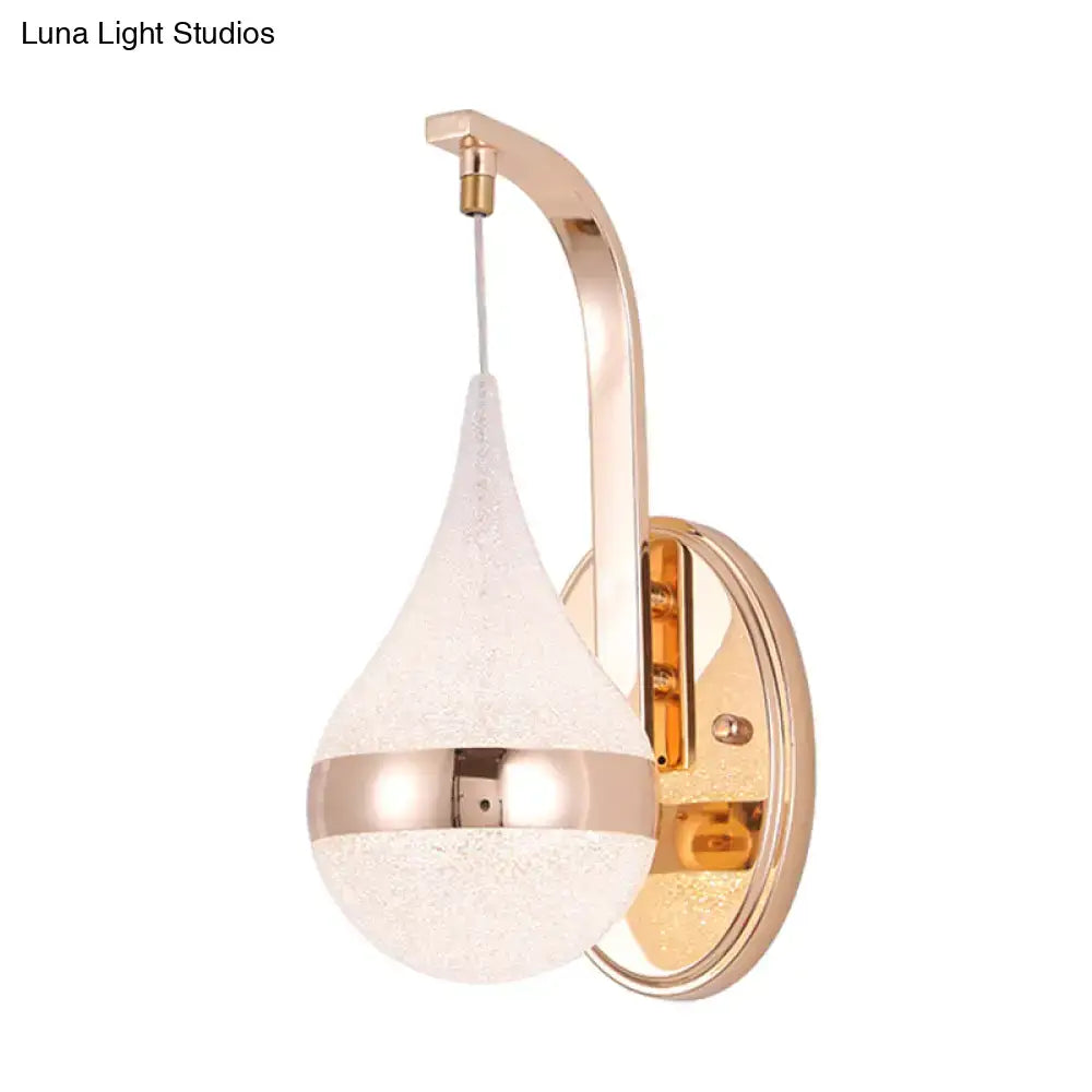 A modern gold acrylic waterdrop wall light fixture with a frosted glass teardrop shade for bedroom sconce lighting