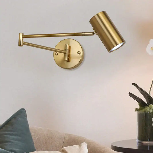 Modern gold wall lamp with adjustable swing arm and cylindrical head ideal for bedroom reading light