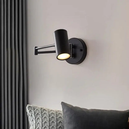 Black matte adjustable swing arm wall lamp with cylindrical head ideal for modern bedroom reading light