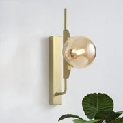 Modern gold and amber glass orb wall light fixture with sleek rectangular base designed for 110v-120v use