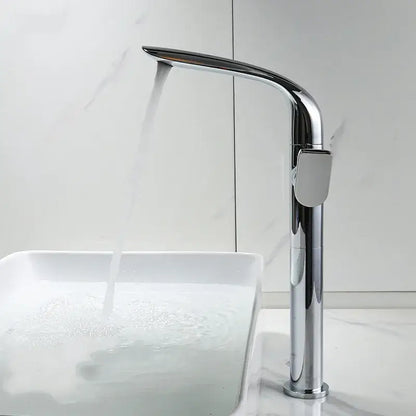 Modern gold and black decorbites basin faucet with chrome high-arc sleek design flowing water into white sink